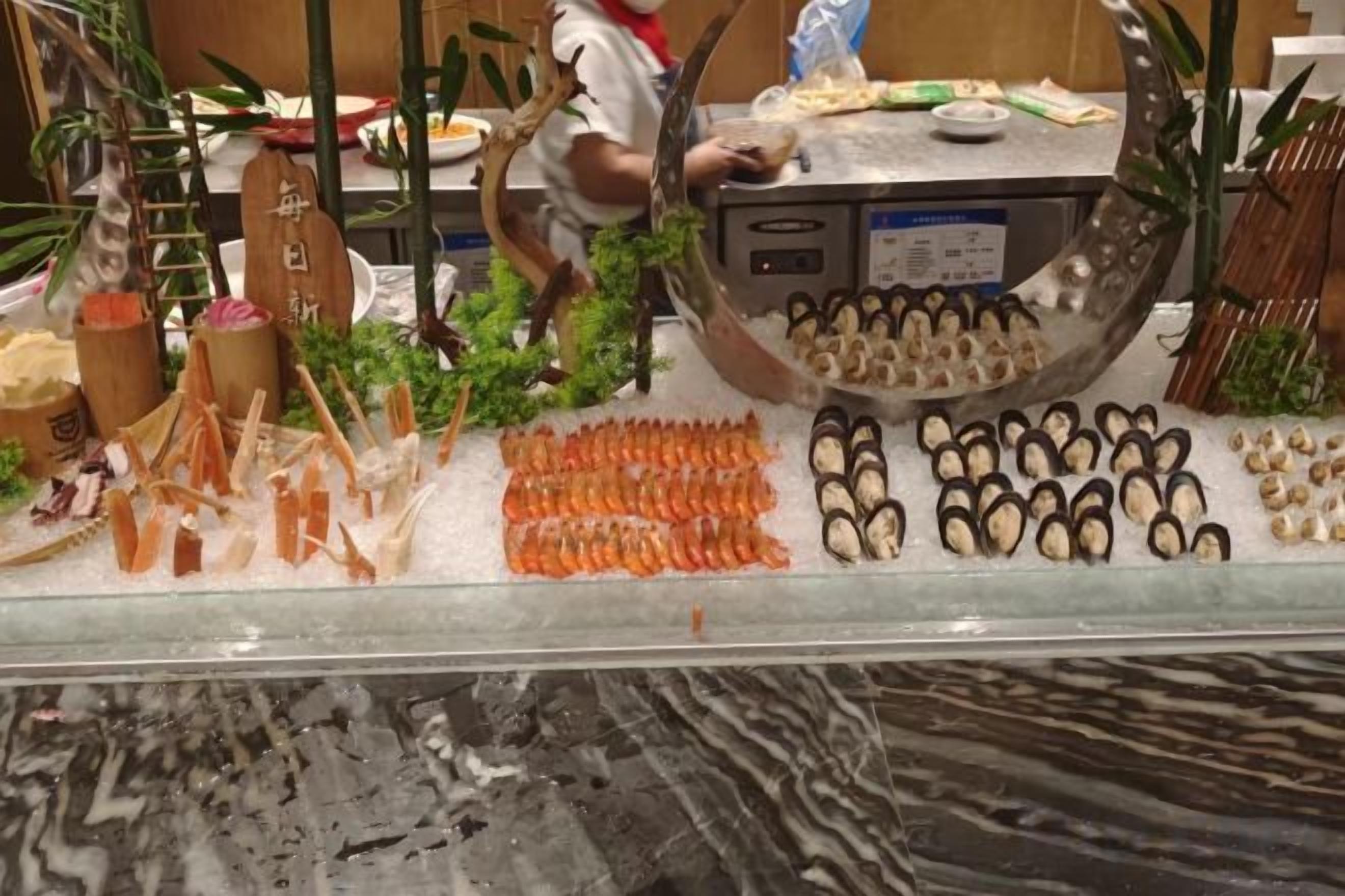 A seafood display with various types of fish and seafood arranged on ice.