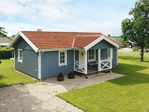 A small, single-story house with a red-tiled roof and a porch. - 7 Person Holiday Home in Svendborg (Svendborg)