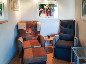A room with two armchairs, a small table, and a sofa. - 6 Person Holiday Home in Hadsund (Hadsund)