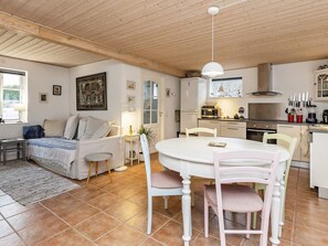 Un intérieur chaleureux comprenant un coin repas, une cuisine et un espace de vie.