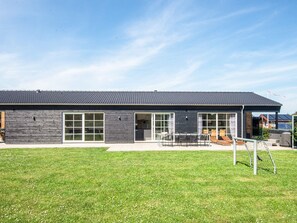 A modern two-story house with a flat roof, large windows, and a covered patio area. - 5 Star Holiday Home in Ansager (Ansager)