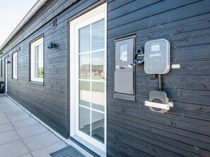 A building with a large glass door and windows, equipped with a security system including a control panel and a door lock. - 5 Star Holiday Home in Ansager (Ansager)