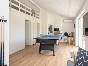 Enjoy dining and socializing in this spacious room, featuring a ping pong table and kitchen counter.