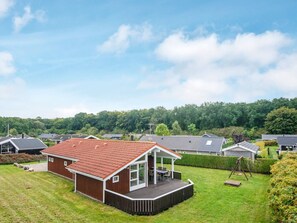 A residential property with a covered patio, a fenced yard, and a view of neighboring houses. - 4 Star Holiday Home in Juelsminde (Horsens)
