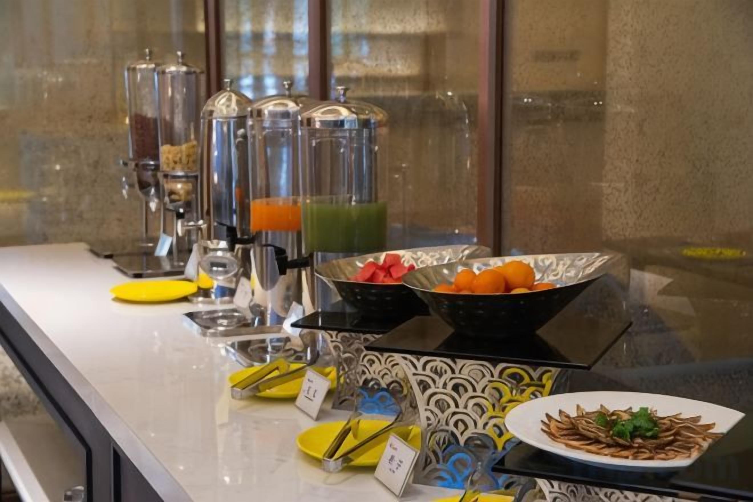 A buffet setup with various food items and beverages.