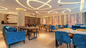 A modern hotel lobby with a central seating area, a reception desk, and a large window with a view. - Yuemei Wanxiang Hotel (Zunyi)