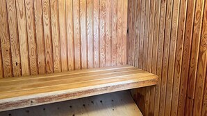 A wooden bench with a metal frame, positioned against a wall with vertical wooden planks. - 5 Person Holiday Home in Tyreso (Tyreso)