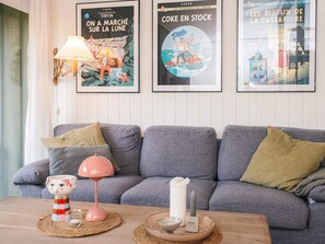 A living room with a grey sofa, a wooden coffee table, and three framed posters on the wall. - 4 Star Holiday Home in Ulfborg (Ulfborg)