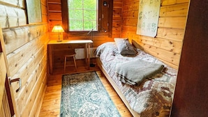 A compact wooden cabin room with a single bed, a desk, and a window. - 6 Person Holiday Home in Blentarp (Blentarp)