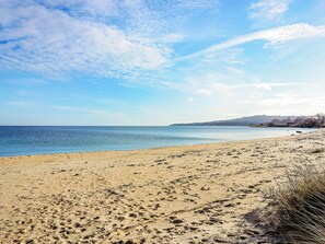 A beach with footprints, a clear sky, and a distant shoreline. - 6 Person Holiday Home in Blentarp (Blentarp)