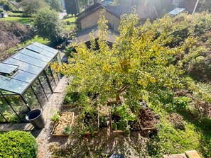 A rooftop garden with a variety of plants and a greenhouse structure. - 7 Person Holiday Home in Svangsta (Svangsta)