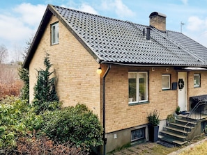 A two-story brick house with a tiled roof, a chimney, and a front entrance with steps. - 7 Person Holiday Home in Svangsta (Svangsta)