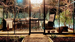 A glass-enclosed patio with a sofa, chairs, and a dining table. - 7 Person Holiday Home in Svangsta (Svangsta)