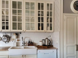 A kitchen with white cabinets, a sink, a coffee maker, and a dishwasher. - 4 Star Holiday Home in Langshyttan (Langshyttan)