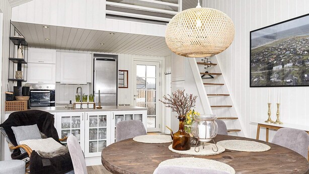 A modern kitchen with white cabinetry, a large island, and a hanging woven light fixture. - 6 Person Holiday Home in Logstor (Logstor)