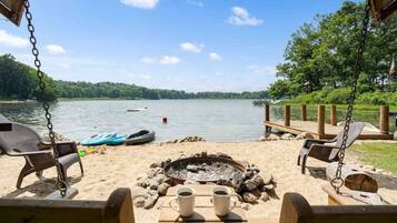 Relax on the lakeside deck with a fire pit, perfect for unwinding with a cup of coffee.
