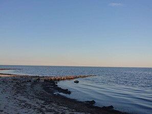 A calm sea with a rocky breakwater and a clear sky. - 4 Person Holiday Home in Idestrup (Idestrup)