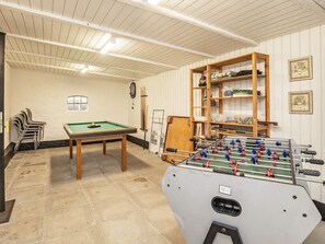 A room with a pool table, a foosball table, and a billiards rack. - 10 Person Holiday Home in Roslev (Roslev)