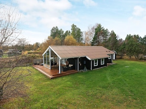 A single-story house with a covered porch and a fenced yard.