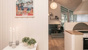 A room with a framed poster, candles, and potted plants on a table. - 4 Star Holiday Home in Jerup (Jerup)
