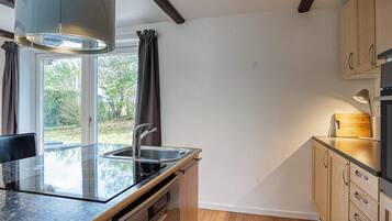 A modern kitchen with a built-in dishwasher, a sink, and a stove.