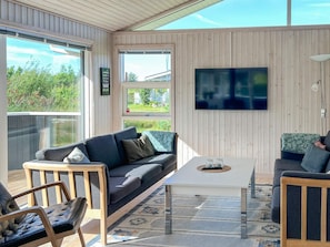 A modern living room with a sofa, coffee table, and chairs. - 7 Person Holiday Home in Logstor (Logstor)