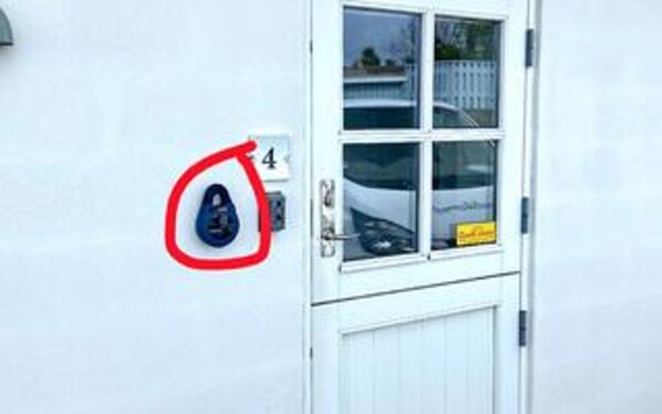 A white door with a window, a number '4' sign, and a red circle highlighting a blue object.