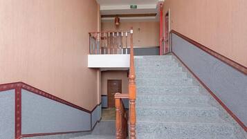 A staircase with wooden handrails and a landing area with a door.