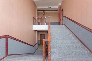 A staircase with wooden handrails and a landing area with a door.