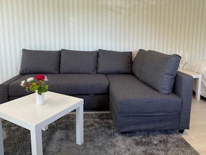 A grey sectional sofa with a white coffee table in front. - 4 Star Holiday Home in Skarhamn (Skaerhamn)