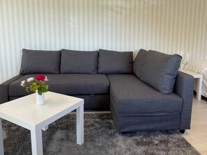 A grey sectional sofa with a white coffee table in front. - 4 Star Holiday Home in Skarhamn (Skaerhamn)