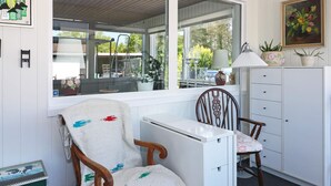 A cozy room with a wooden chair, a small desk, and a white cabinet. - 4 Person Holiday Home in Storvorde (Storvorde)