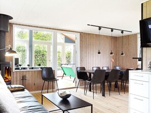 A modern interior with a dining area, kitchen, and seating space. - 7 Person Holiday Home in Holbaek (Holbaek)