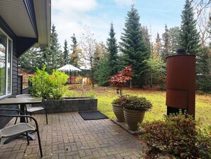 A patio with outdoor seating, a gazebo, and a garden with potted plants. - 4 Person Holiday Home in Hals-by Traum (Hals)