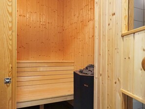 A sauna room with wooden walls and benches. - 4 Star Holiday Home in Bovallstrand (Bovallstrand)