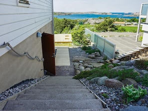 A staircase leading to a house with a view of the sea. - 4 Star Holiday Home in Bovallstrand (Bovallstrand)