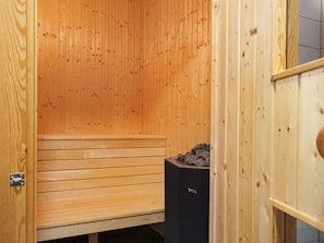 A sauna room with wooden walls and benches. - 4 Star Holiday Home in Bovallstrand (Bovallstrand)