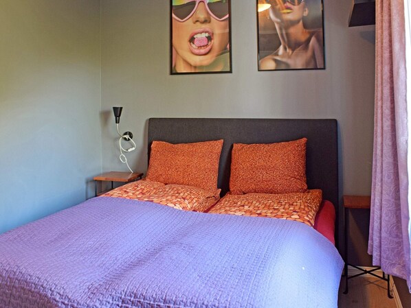 A bed with a patterned bedspread, two pillows, and a headboard. - 5 Person Holiday Home in Frederikstad (Fredrikstad)