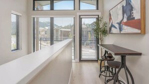 A modern interior with a balcony, large windows, and a painting on the wall. - Modern Mountain 3BR Near Donner Lake & Trails (Truckee)