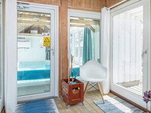 A room with a pool, a chair, and a cart with items. - 4 Star Holiday Home in Fjerritslev (Fjerritslev)