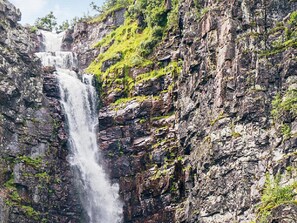A waterfall cascading down a rocky cliff with patches of greenery. - 12 Person Holiday Home in Idre-by Traum (Idre)