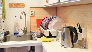 A kitchen with a sink, a kettle, a dish rack, and a power outlet. - 5 Person Holiday Home in Sexdrega-by Traum (Sexdrega)