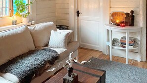 A cozy living room with a white sofa, a coffee table, and a bookshelf. - 5 Person Holiday Home in Lerum-by Traum (Lerum)