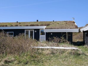 A building with a flat roof, a door, and a window.