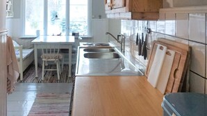 A kitchen with a wooden countertop, a sink, and a window. - 4 Star Holiday Home in Hallabro (Hallaröd)