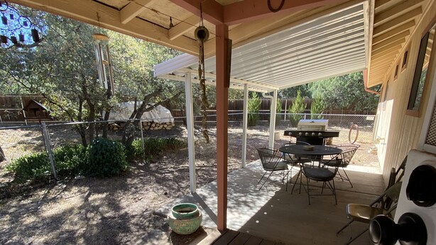 A covered patio with a grill, outdoor seating, and a pergola. - SilverKing Family Retreat - Dog Friendly! (Show Low)