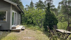 A small house with a porch and a wooden deck. - 3 Person Holiday Home in Uddevalla (Uddevalla)