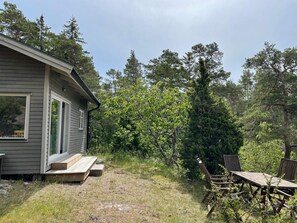 A small house with a porch and a wooden deck. - 3 Person Holiday Home in Uddevalla (Uddevalla)