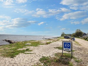A coastal road with a speed limit sign indicating 20 km/h. - 6 Person Holiday Home in Sjolund (Sjølund)