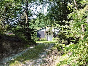A rustic cabin surrounded by dense forest. - 4 Person Holiday Home in Aars (Aars)